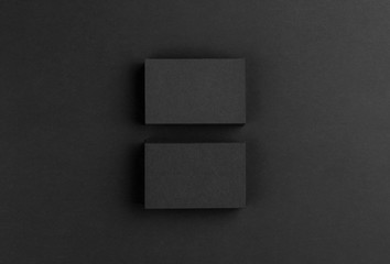 Black business cards isolated on black background