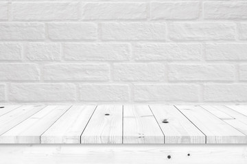 Empty wooden table with white brick wall background.