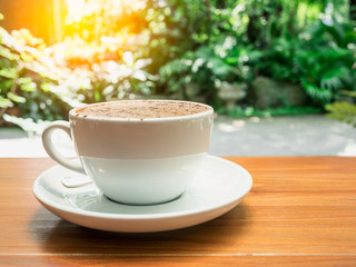 hot coffee cup on wood table.