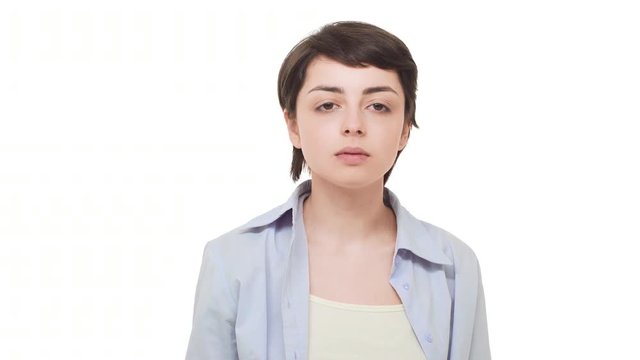 Young tired Caucasian female with short hait sighin heavily over white background and doing double facepalm making faces