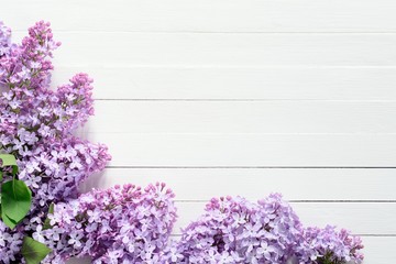 Lilac flowers floral background. Lilac flowers frame composition with copy space on vintage white wooden background.
