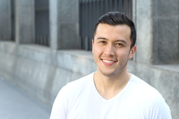 Young Hispanic male smiling outside 