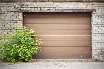 Garage wooden plank door, dirty grunge brick wall background