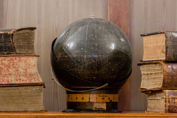 Ancient books and a globe of heavenly constellations