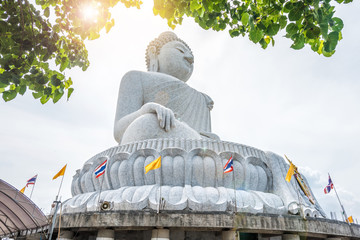 Big Buddha statue Was built on a high hilltop of Phuket Thailand Can be seen from bodhi tree is symbol buddhism. Famous place and most popular for tourist in vacation © powerbeephoto