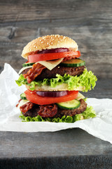 fresh tasty burger on wooden grey background