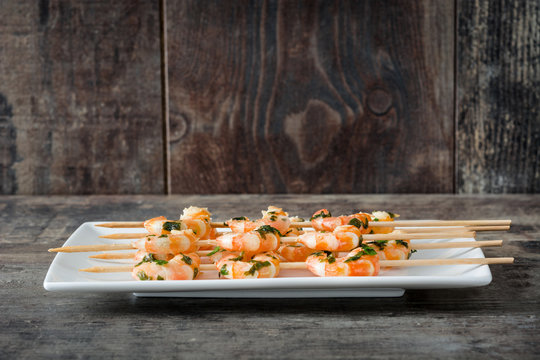 Shrimp skewers on wooden table
