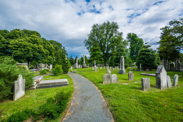 Fototapeta na wymiar Walkway and graves at Laurel Hill Cemetery, in Philadelphia, Pennsylvania.