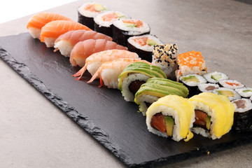 close up of sashimi sushi set with chopsticks and soy - sushi roll with salmon and sushi roll with smoked eel, selective focus.