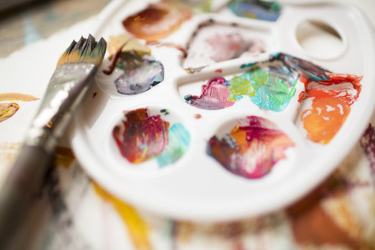 Close detail of a painters pallet and brush