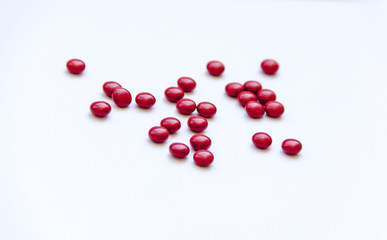 Red pills on white background