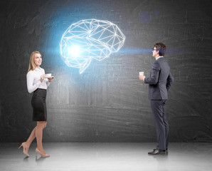 Business duo with coffee and a brain hologram
