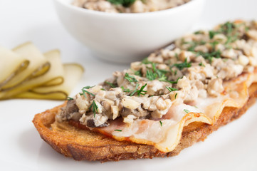 mushrooms bacon toast garnished with pickled cucumber