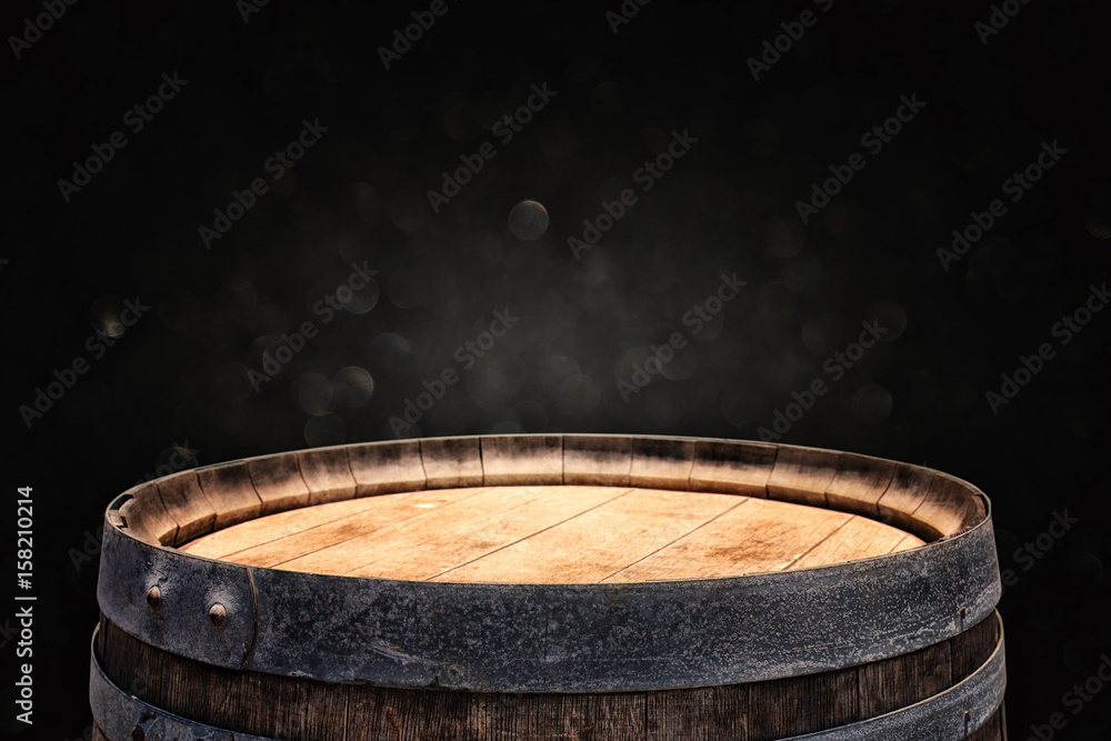 Wall mural image of old oak wine barrel in front of black background