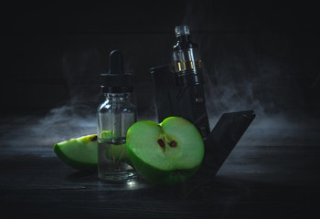 black vaporizer in the smoke with sliced apple