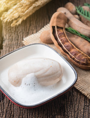Tamarind soap with Tamarind pods on wood background