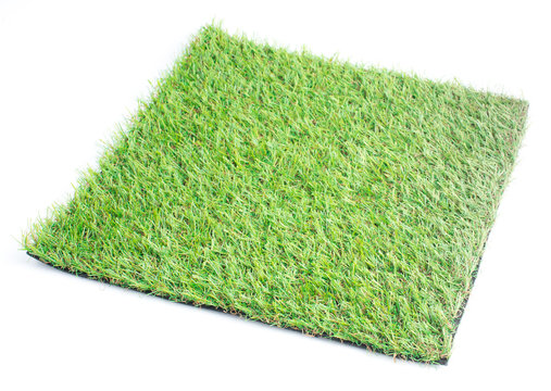 Patch of green artificial grass on a white background