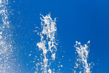 Splashing water against the blue sky