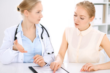 Doctor and  patient  sitting at the desk 