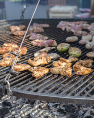 Cooking meat on the grill at street food market