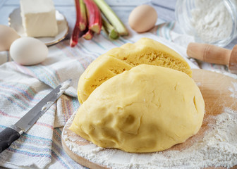 Prepared dough for rhubarb pie with ingredients