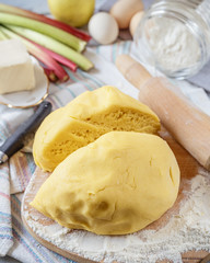Prepared dough for rhubarb pie with ingredients