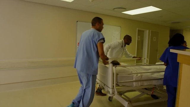 Doctors and nurses pushing hospital bed