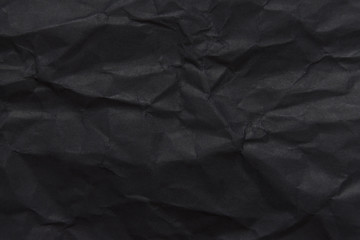 The background paper, crumpled black