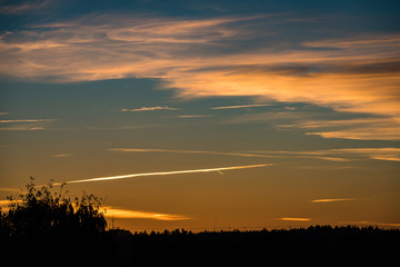 abstract colored sunset sky with broken clouds