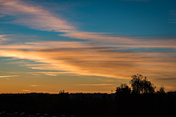 abstract colored sunset sky with broken clouds