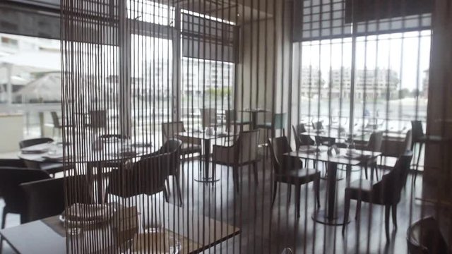 Tables set for service in empty restaurant