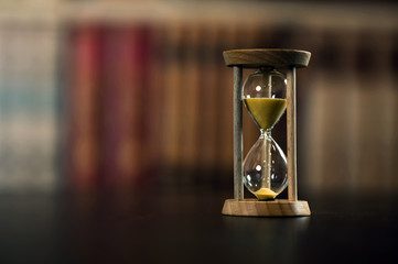 Hourglass and books