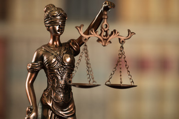 Lady Justice and law books in court