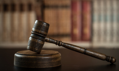 Judge hammer, scales of justice and law books in court