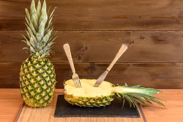 Ripe anans on a wooden table and background texture with free space for writing