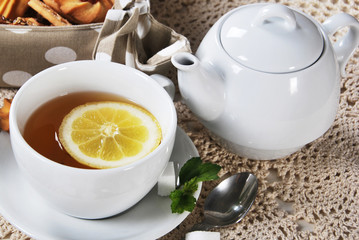 White cup of tea with breakfast cookies