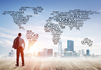 Motivation and inspiration concept with modern cityscape and businessman observing it