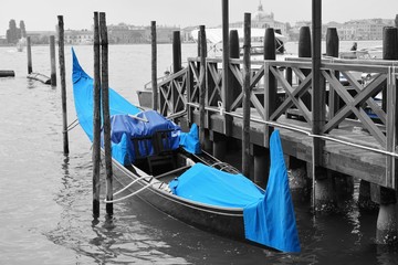 Black and white and blue shot of gondola boats on the Grand Canal in Venice, Italy
