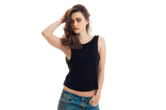 Portrait of sexual young girl in a black t-shirt and shorts that keeps hair hand