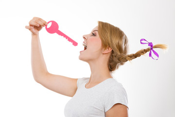 Teenage girl with braid biting key