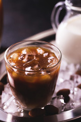 Iced coffee with milk and chocolate truffles in glasses