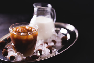 Iced coffee with milk and chocolate truffles in glasses