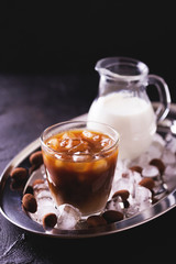 Iced coffee with milk and chocolate truffles in glasses