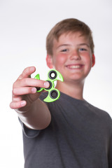Boy holding out fidget spinner