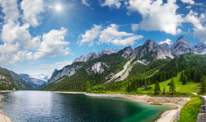 Naklejka na ściany i meble Alpine summer lake sunshiny panorama.
