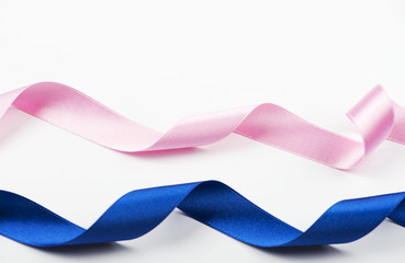 Background of blue and pink ribbons on white background.