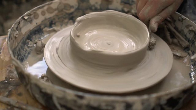 Hands of teeneger working with clay