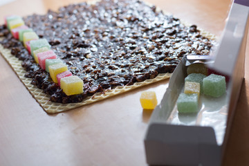 Chocolate topping with wallnuts on cake crust for rolled chocolate cake