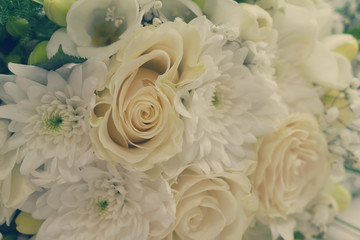 white fresh roses, freesia and mum flowers bouquet background, retro toned
