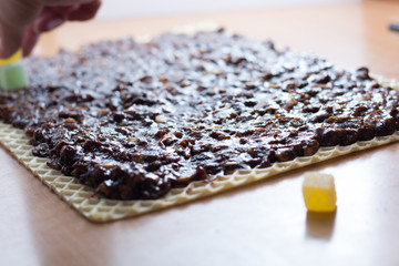Chocolate topping with wallnuts on cake crust for rolled chocolate cake